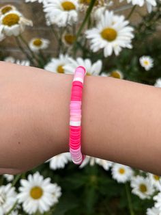 pink and white clay bead bracelet with gold cube beads at the bottom. Hot Pink Clay Bead Bracelet, Casual Pink Friendship Bracelets With Tiny Beads, Pink Round Beads Stretch Bracelet For Everyday, Pink Stretch Bracelet With Round Beads For Everyday, Casual Pink Friendship Bracelet With Tiny Beads, Pink Heishi Beads Beaded Bracelets, Pink Heishi Beads Stretch Bracelet, Everyday Pink Beaded Bracelets With Letter Beads, Pink Everyday Bracelet With Round Beads