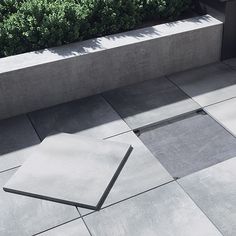 a cement bench sitting on top of a tiled floor