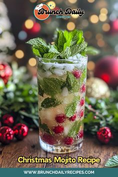 christmas mojito recipe in a glass with mint and cranberries on the side