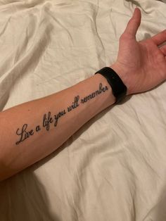 a person with a tattoo on their arm saying live a life you will remember