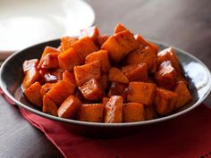 a bowl filled with cooked sweet potatoes on top of a table