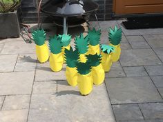 several pineapples are placed in front of a bbq