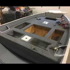 the inside of a boat with some tools in it's storage compartment on display