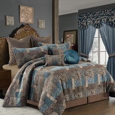 a bed with blue and brown comforters in a bedroom