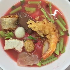 a white bowl filled with lots of different types of food