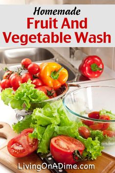 fresh fruits and vegetables are sitting on a cutting board in front of a sink with the words homemade fruit and vegetable wash