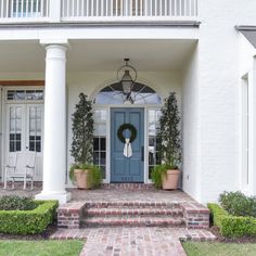 a blue front door on a white house