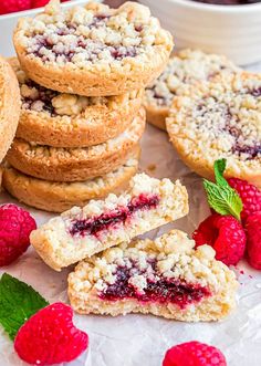 raspberry crumble cookies stacked on top of each other next to fresh raspberries