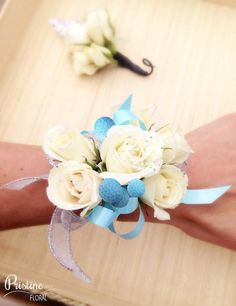 a person's arm with flowers on it and an umbrella attached to the wrist