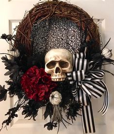 a wreath with a skull and flowers on it