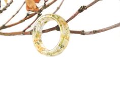 "Wear this ring and literally have summer in the palm of your hand... Eco resin ring with Baby's breath and gold flakes. They are about 7mm wide, 1/8\" (4mm) thick, so they look wonderful on their own, or as chunky stacking rings. Each one is handmade from start to finish, and come in a variety of sizes. Made with high grade eco-friendly jewelers resin. Glossy surface. For help figuring out your ring size, check out http://en.wikipedia.org/wiki/Ring_size Each finished jewelry listing will arrive White Jewelry For Spring Gifts, Yellow Rings For Summer Gift, Spring Yellow Round Jewelry, White Spring Festival Jewelry, White Flower Ring For Spring Gift, White Ring Jewelry For Spring, Summer Flower Shaped Jewelry Gift, Spring White Flower Ring As A Gift, Yellow Resin Jewelry As A Gift