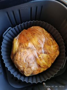 an uncooked meat in a plastic container on top of a stove burner