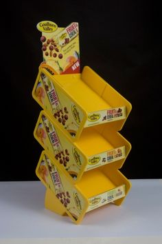 three yellow boxes stacked on top of each other in front of a black background,