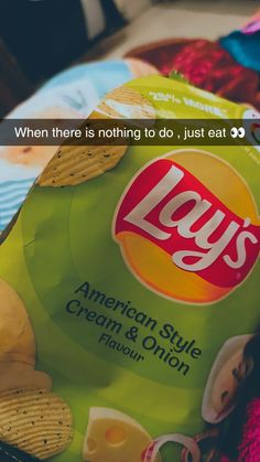 a bag of lays potato chips sitting on top of a pile of other food items