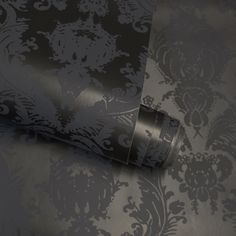 the wall paper is black and white with an intricate design on it's surface