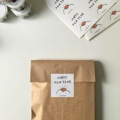 a brown bag sitting on top of a white table next to some tape and scissors