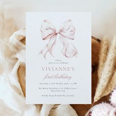 a white card with a pink bow on it