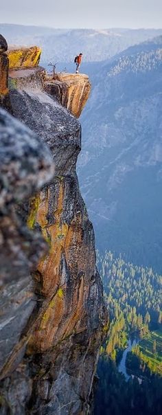 a man standing on the edge of a cliff