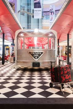 a silver and black checkered floor with luggage on it