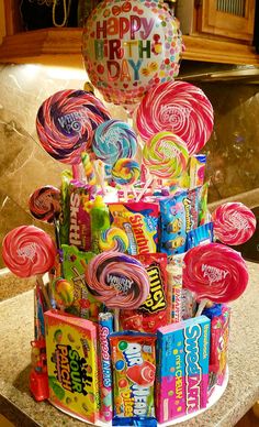 a birthday cake made out of candy and lollipops