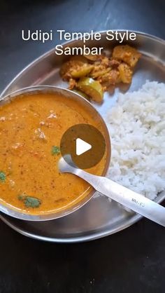 a metal plate topped with rice and curry