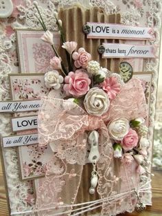 a close up of a card with flowers and lace on the front, along with words that read love is a moment