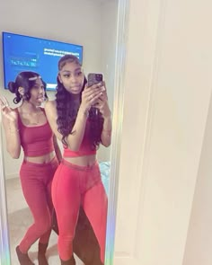 two women in matching outfits taking a selfie