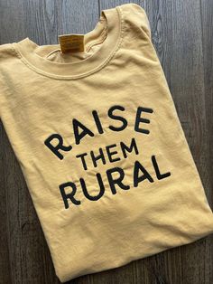 The most comfortable tee! Customize your t shirt with  the thread color of your choice!  EMBROIDERED DESIGN features a large bold font that reads "Raise Them Rural" OTHER SIZES AND COLORS AVAILABLE UPON REQUEST This shirt is Comfort Colors! .: 100% ring-spun cotton .: Medium fabric (6.1 oz/yd² (206.8 g/m .: Relaxed fit .: Sewn-in twill label **Each item is made to order, therefore we can not accept returns and exchanges. HOWEVER, if there is an issue with your order PLEASE contact us before leav Fun Mom Shirts, Farm Mom Aesthetic, Inspirational Shirt Ideas, Farmgirl Outfits, Mom Tshirt Ideas, Farming Shirts, Great Grandma Shirt, Farming Family, Hippie Mom