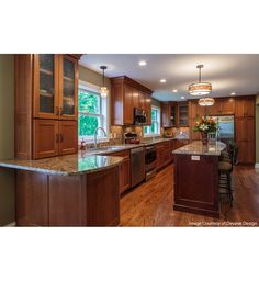 a large kitchen with wooden cabinets and granite counter tops