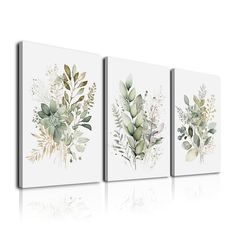 three canvases with flowers and leaves on them, one is white and the other is green