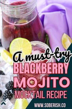 a mason jar filled with blackberry mojito next to lemons and blackberries