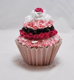 a cupcake decorated with pink, black and white ruffles