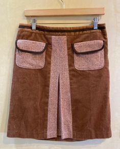 This early Ann Taylor Loft skirt features corduroy with tweedy inset and front flap pockets, velour waist and and brown piping on pockets and waistband. Side zipper.  Fully lined.  Made in Thailand. Dry clean.  Skirt Body 100% Cotton  Pockets and Insert 56% Wool 44% Rayon Lining 100% Acetate Label says size 8 Detailed Measurements: Waist - 31 inches  Hip - 38 inches  Length - 20 inches Womens Skirts, Ann Taylor Loft, Flap Pocket, Side Zipper, Ann Taylor, Mixed Media, Womens Skirt, Thailand, Zipper