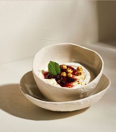 a white bowl filled with food on top of a table