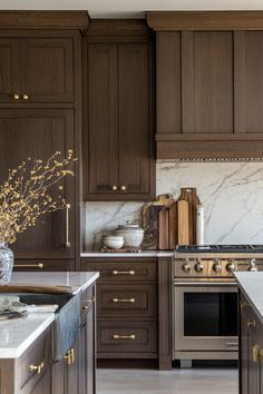 a kitchen with marble counter tops and wooden cabinets