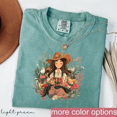 Cowgirl Graphic Tee - Horse and Wildflower Design - Western Country Apparel PRODUCTION AND SHIPPING  Production: 1-3 days Standard Shipping (3-5 business days after production time) T-shirts and Sweatshirts are professionally PRINTED they are the highest quality print possible, like the quality you would expect from a retail shop bought T-shirt.  HOW TO ORDER YOUR CUSTOM DESIGN T-SHIRT  * Choose your t-shirt color * Choose your size * Choose your design & text color We absolutely love customizing orders for people! The best feeling is being able to add a personal touch to our designs to make our customers happy. If you would like to tweak this design with a name on the back or add some additional text all you have to do is add this listing to your cart with the shirt as well. DETAILS Our R Country Apparel, Cowgirl Graphic, Country Girl Shirts, Wildflower Design, Western Style Shirt, Cowgirl And Horse, Boho Cowgirl, Country Girl Style, Cowgirl Shirts