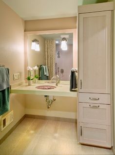 a bathroom with a sink, mirror and towel rack