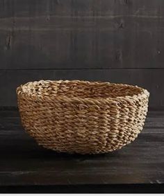 a woven basket sitting on top of a wooden table