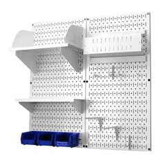 a white pegboard wall with blue bins and two shelves on each side,