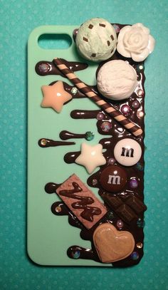 an iphone case with chocolate, marshmallows, and candies on it