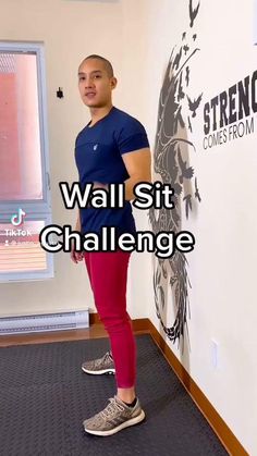 a woman standing in front of a wall with the words wall sit challenge