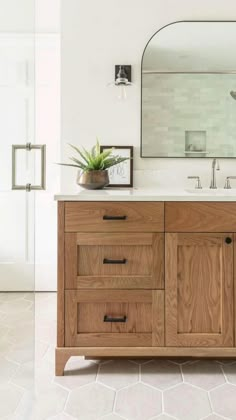 a bathroom with two sinks and a large mirror