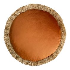 a round dog bed made out of straw with an orange cushion on top and fringe trim around the edges