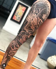 a woman's leg with tattoos on it