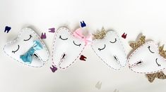 three toothbrush holders are decorated with glitters and bowknots to look like unicorns