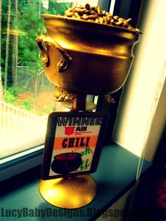 a gold urn sitting on top of a window sill next to a window