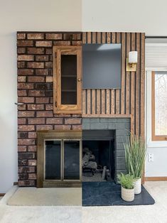 a living room with a brick fireplace and tv