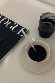 a cup of coffee and a book on a table