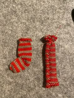 two red and white knitted items laying on the ground