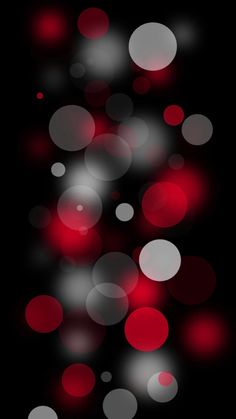 red and white circles are shown in this dark background, with the light shining through them